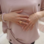 pink top and gold jewelries
